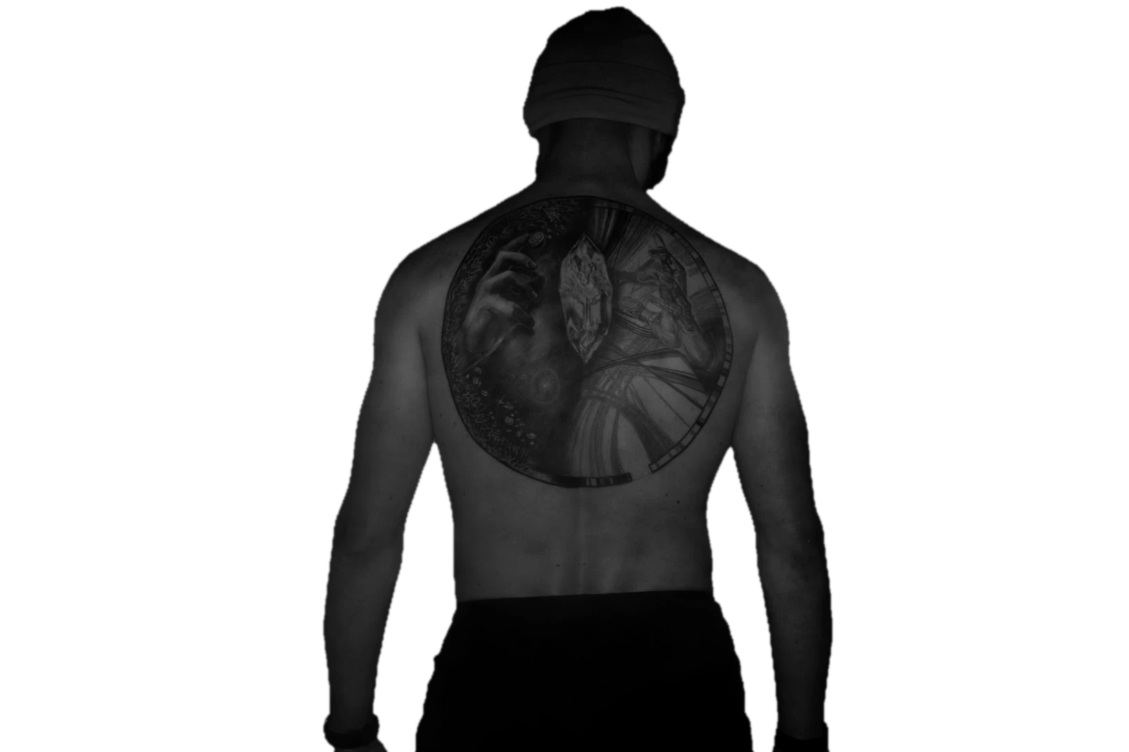 Greyscale cutout portrait of Meryll Dindin, head to waist, the circular tattoo visible on his upper back.